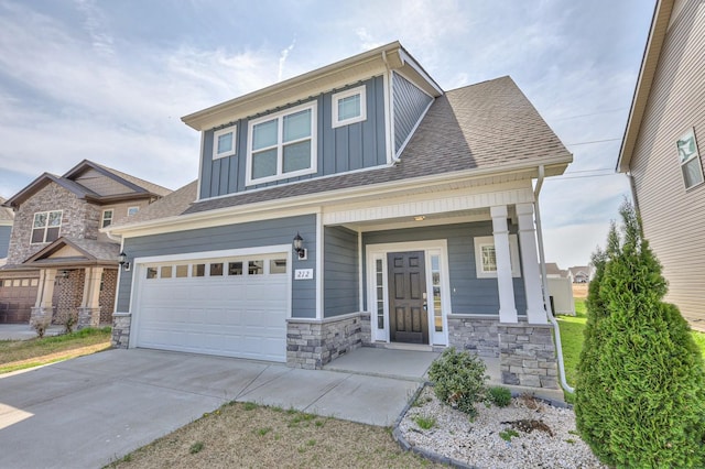 212 Eusa Cantrell Ln, Smyrna, TN 37167 - craftsman-style house with board and batten siding, driveway, stone siding, an attached garage, and a porch