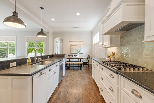 1202 Jewell Ave, Franklin, TN 37064 - kitchen featuring premium range hood, appliances with stainless steel finishes, arched walkways, dark wood-type flooring, and tasteful backsplash