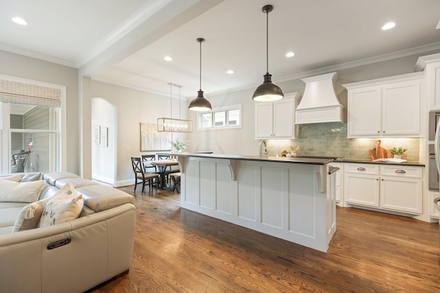 1202 Jewell Ave, Franklin, TN 37064 - kitchen featuring custom exhaust hood, open floor plan, dark countertops, tasteful backsplash, and white cabinets