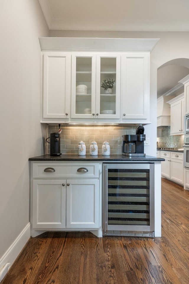 1202 Jewell Ave, Franklin, TN 37064 - bar with wine cooler, tasteful backsplash, appliances with stainless steel finishes, arched walkways, and ornamental molding