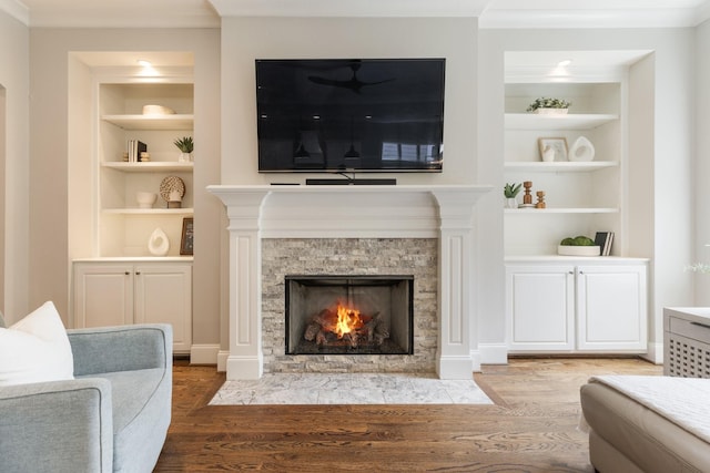 1202 Jewell Ave, Franklin, TN 37064 - living room featuring built in shelves, wood finished floors, ornamental molding, and a fireplace with flush hearth