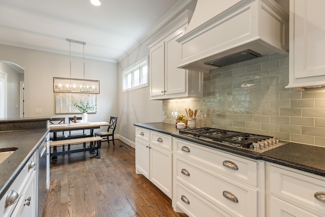 1202 Jewell Ave, Franklin, TN 37064 - kitchen with custom exhaust hood, appliances with stainless steel finishes, arched walkways, and decorative backsplash