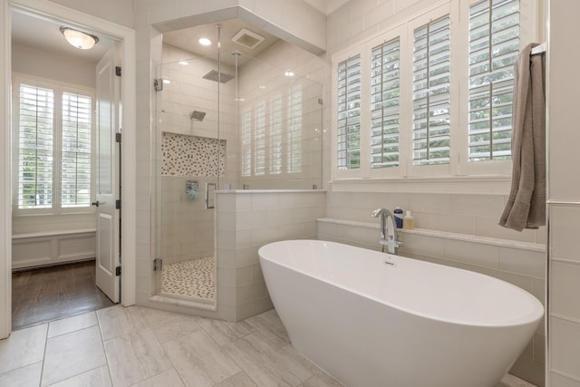 1202 Jewell Ave, Franklin, TN 37064 - bathroom featuring a shower stall, a soaking tub, and tile walls