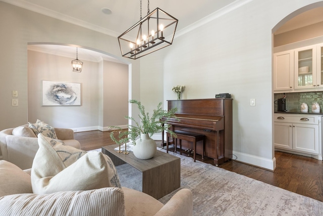 1202 Jewell Ave, Franklin, TN 37064 - living area with arched walkways, dark wood-style flooring, ornamental molding, and a chandelier