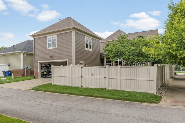 1202 Jewell Ave, Franklin, TN 37064 - view of property exterior featuring a gate, an attached garage, concrete driveway, and a shingled roof