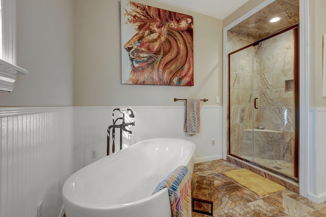 6353 Gordon Lawrence Rd, Santa Fe, TN 38482 - full bath featuring stone finish floors, a soaking tub, a wainscoted wall, and a shower stall