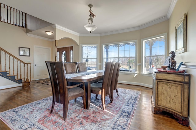 6353 Gordon Lawrence Rd, Santa Fe, TN 38482 - dining area featuring wood finished floors, stairway, ornamental molding, and arched walkways