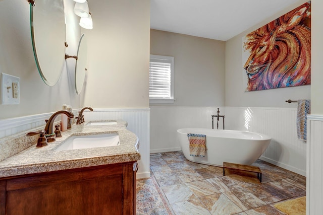 6353 Gordon Lawrence Rd, Santa Fe, TN 38482 - full bath featuring double vanity, wainscoting, a soaking tub, and stone finish floors