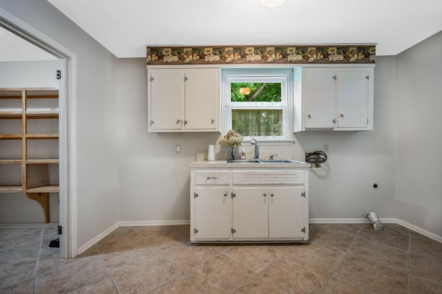 305 E Overhill Dr, Dickson, TN 37055 - laundry room featuring electric dryer hookup, cabinet space, and light tile patterned floors