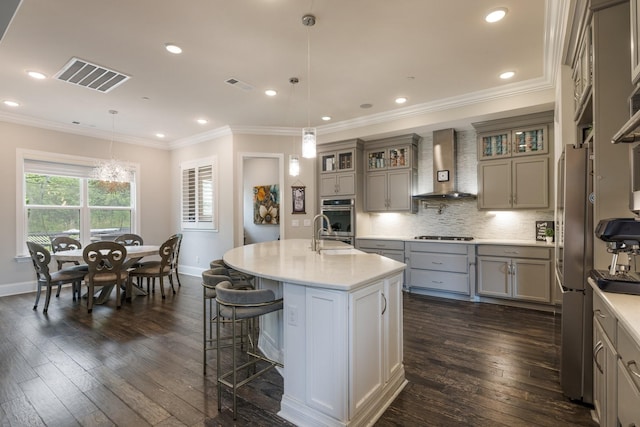 9488 Stillbrook Trce, Brentwood, TN 37027 - kitchen featuring wall chimney exhaust hood, gray cabinets, light countertops, an island with sink, and dark wood finished floors