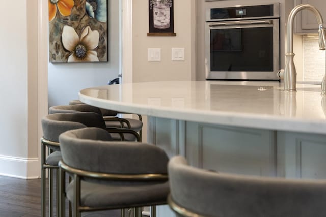 9488 Stillbrook Trce, Brentwood, TN 37027 - bar featuring stainless steel oven and dark wood-style floors