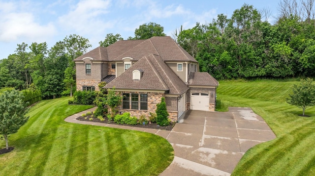 9488 Stillbrook Trce, Brentwood, TN 37027 - french country inspired facade with concrete driveway, stone siding, an attached garage, and a front yard