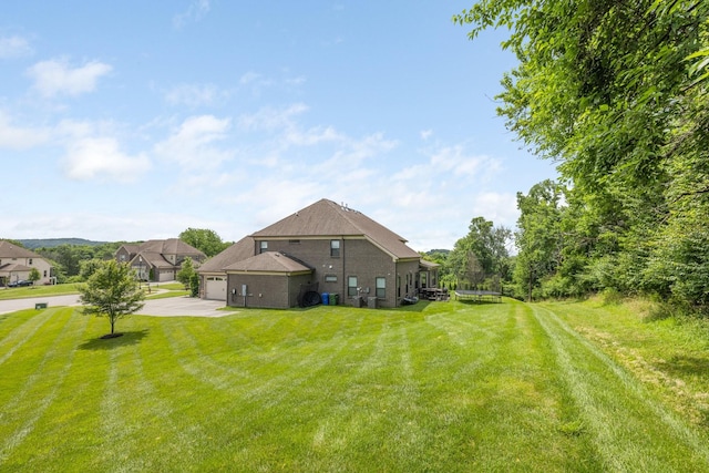 9488 Stillbrook Trce, Brentwood, TN 37027 - rear view of property with concrete driveway, a lawn, and an attached garage