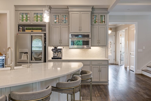 9488 Stillbrook Trce, Brentwood, TN 37027 - kitchen featuring fridge with ice dispenser, gray cabinets, a kitchen breakfast bar, crown molding, and backsplash