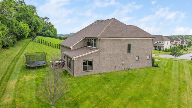9488 Stillbrook Trce, Brentwood, TN 37027 - back of property with a trampoline, brick siding, and roof with shingles