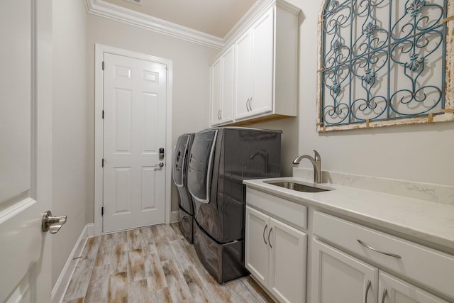 9488 Stillbrook Trce, Brentwood, TN 37027 - laundry room featuring cabinet space, crown molding, light wood-type flooring, and washing machine and clothes dryer