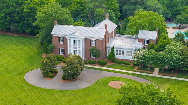 9488 Stillbrook Trce, Brentwood, TN 37027 - view of front of house with a chimney, a standing seam roof, a metal roof, a front lawn, and curved driveway