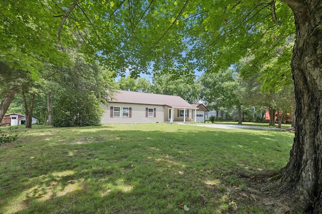 631 W Maple St, Morrison, TN 37357 - ranch-style home with a front yard, a metal roof, driveway, and a garage