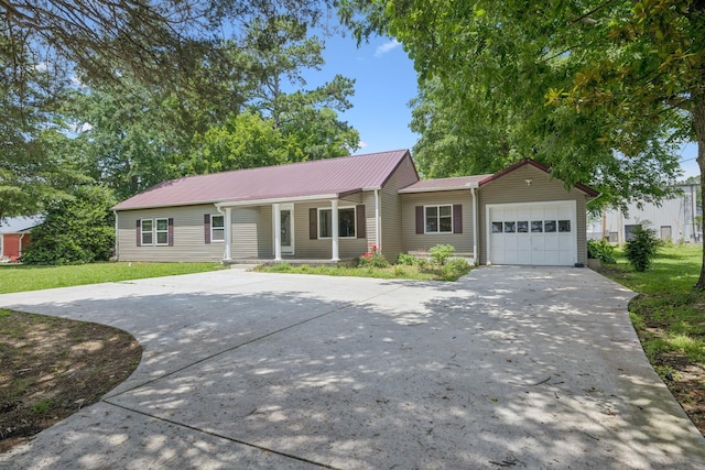 631 W Maple St, Morrison, TN 37357 - ranch-style home with concrete driveway, a garage, and a metal roof