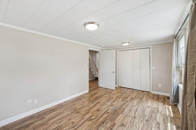 631 W Maple St, Morrison, TN 37357 - unfurnished bedroom featuring ornamental molding, a closet, and wood finished floors