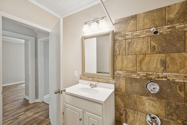 631 W Maple St, Morrison, TN 37357 - bathroom featuring vanity, crown molding, wood finished floors, and decorative backsplash