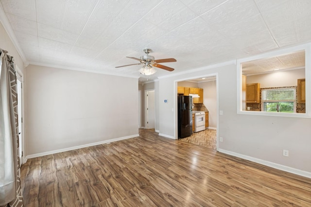 631 W Maple St, Morrison, TN 37357 - unfurnished living room featuring wood finished floors, ceiling fan, and crown molding
