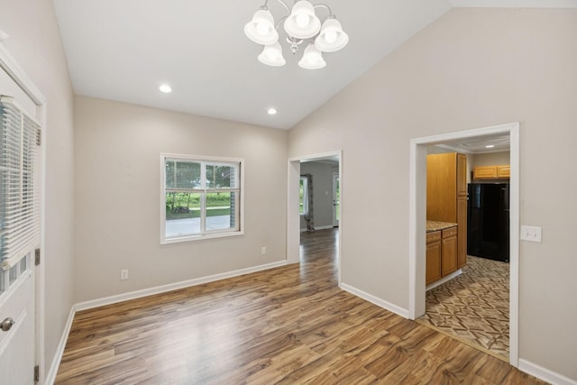 631 W Maple St, Morrison, TN 37357 - empty room featuring light wood-style floors, a chandelier, recessed lighting, and high vaulted ceiling