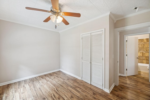 631 W Maple St, Morrison, TN 37357 - unfurnished bedroom with crown molding, a closet, wood finished floors, and ceiling fan