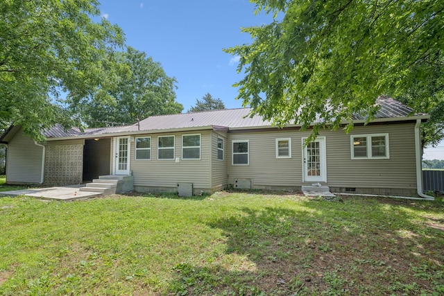 631 W Maple St, Morrison, TN 37357 - rear view of house featuring entry steps, a yard, and a metal roof