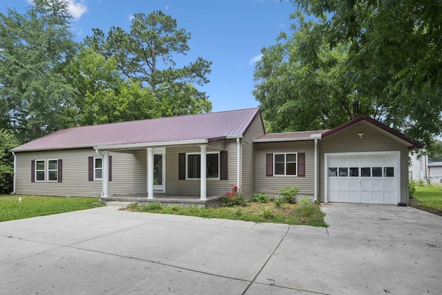 631 W Maple St, Morrison, TN 37357 - single story home featuring driveway, a porch, a garage, and a metal roof