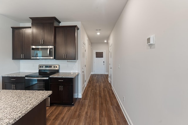 858 Longleaf Ln, Columbia, TN 38401 - kitchen featuring appliances with stainless steel finishes, dark wood-style flooring, dark brown cabinets, light stone counters, and recessed lighting
