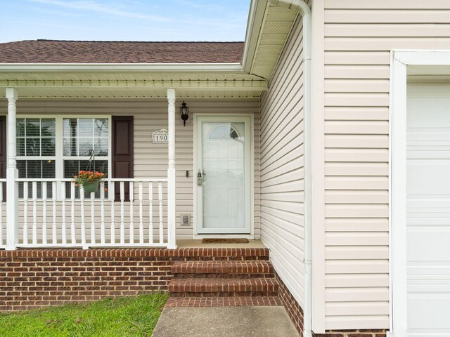 1908 Sheffield Ln, Columbia, TN 38401 - view of exterior entry featuring roof with shingles, covered porch, and a garage