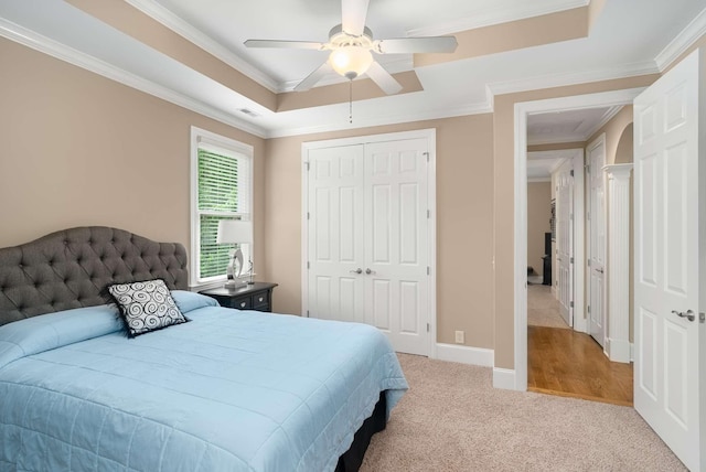 241 King Arthur Cir, Franklin, TN 37067 - bedroom with carpet flooring, a tray ceiling, ornamental molding, a closet, and ceiling fan
