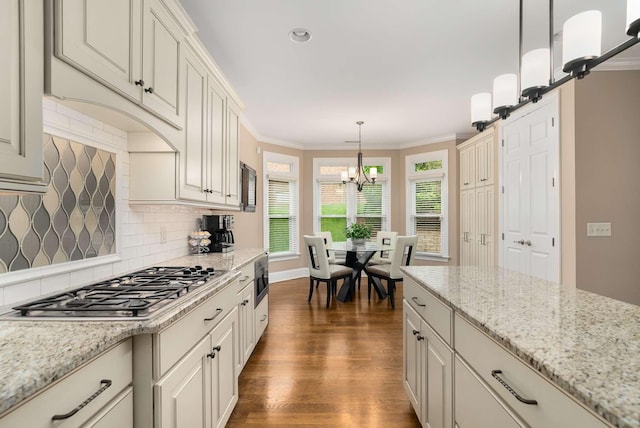 241 King Arthur Cir, Franklin, TN 37067 - kitchen with stainless steel gas cooktop, dark wood finished floors, decorative backsplash, a chandelier, and crown molding