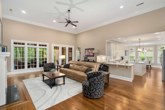241 King Arthur Cir, Franklin, TN 37067 - living room with wood finished floors, recessed lighting, a chandelier, ceiling fan, and ornamental molding