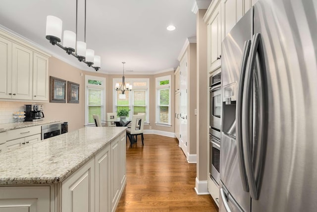 241 King Arthur Cir, Franklin, TN 37067 - kitchen featuring stainless steel fridge, a chandelier, ornamental molding, decorative backsplash, and wood finished floors