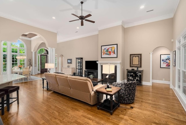 241 King Arthur Cir, Franklin, TN 37067 - living room with decorative columns, arched walkways, ceiling fan, wood finished floors, and recessed lighting
