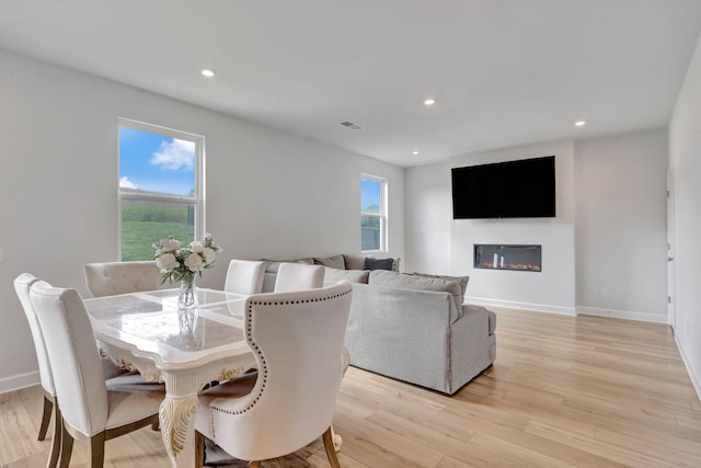120 Millbrook Dr, Spring Hill, TN 37174 - dining space featuring light wood-style floors, recessed lighting, and a glass covered fireplace