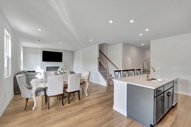 120 Millbrook Dr, Spring Hill, TN 37174 - dining area featuring stairway, light wood-style flooring, recessed lighting, healthy amount of natural light, and a glass covered fireplace