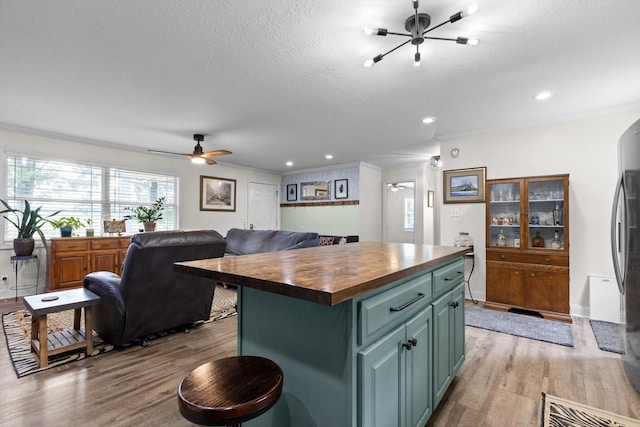 1060 Anderson Ridge Rd, Jasper, TN 37347 - kitchen featuring butcher block countertops, light wood-style flooring, green cabinetry, a ceiling fan, and a textured ceiling