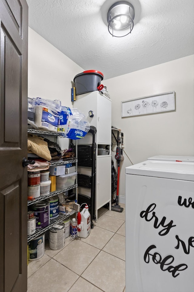 1060 Anderson Ridge Rd, Jasper, TN 37347 - laundry room featuring light tile patterned floors, washer and dryer, and a textured ceiling