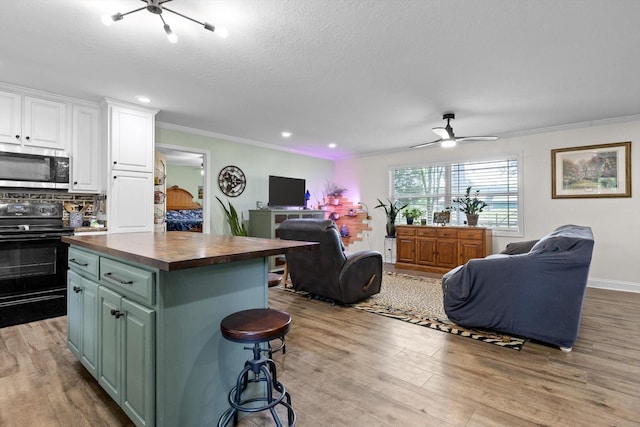1060 Anderson Ridge Rd, Jasper, TN 37347 - kitchen featuring stainless steel microwave, black electric range, open floor plan, butcher block countertops, and crown molding