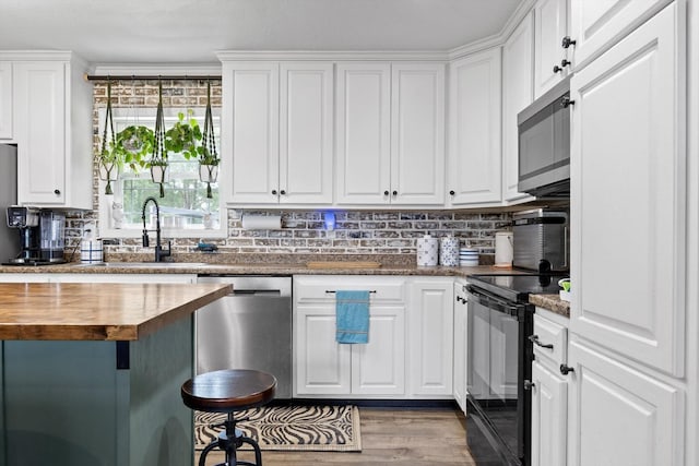 1060 Anderson Ridge Rd, Jasper, TN 37347 - kitchen featuring appliances with stainless steel finishes, butcher block counters, and white cabinets