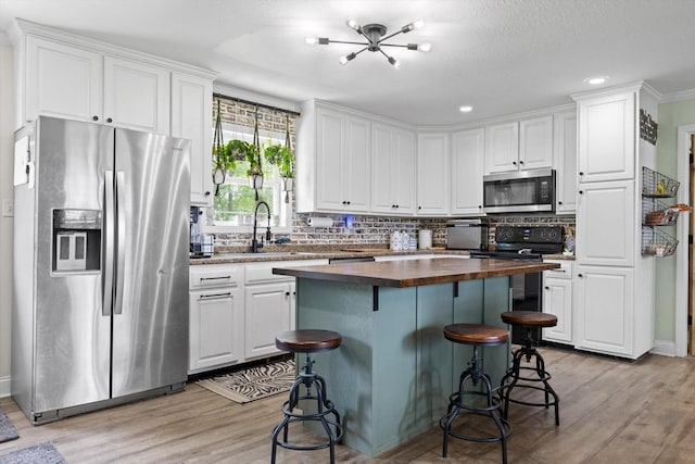 1060 Anderson Ridge Rd, Jasper, TN 37347 - kitchen featuring stainless steel appliances, wooden counters, white cabinetry, light wood-style flooring, and recessed lighting