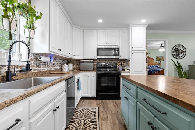 1060 Anderson Ridge Rd, Jasper, TN 37347 - kitchen with stainless steel appliances, butcher block countertops, white cabinets, wood finished floors, and backsplash