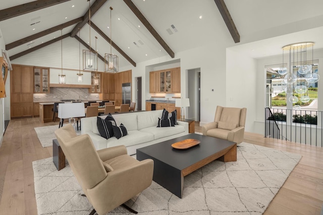 7346 Harlow Dr, College Grove, TN 37046 - living area featuring high vaulted ceiling, light wood finished floors, beamed ceiling, recessed lighting, and a chandelier