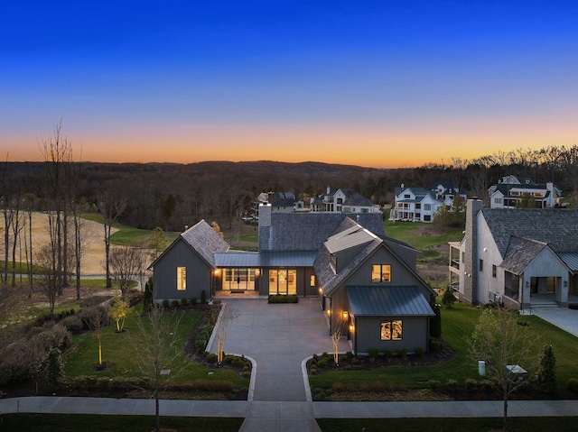 7346 Harlow Dr, College Grove, TN 37046 - view of front of home with a standing seam roof, curved driveway, a chimney, and a metal roof
