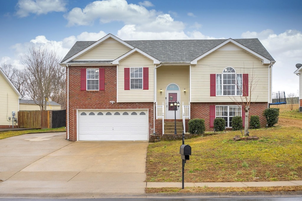 1661 Cedar Springs Ct, Clarksville, TN 37042 - bi-level home featuring brick siding, concrete driveway, an attached garage, and roof with shingles