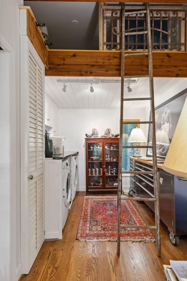 232 Hollingsworth Cove Rd, Monteagle, TN 37356 - laundry area featuring cabinet space, wood finished floors, washer and clothes dryer, and track lighting