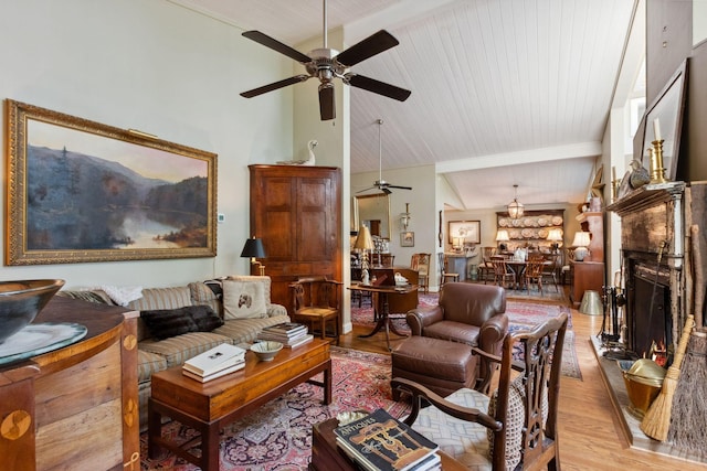 232 Hollingsworth Cove Rd, Monteagle, TN 37356 - living room with a ceiling fan, light wood-type flooring, and a warm lit fireplace